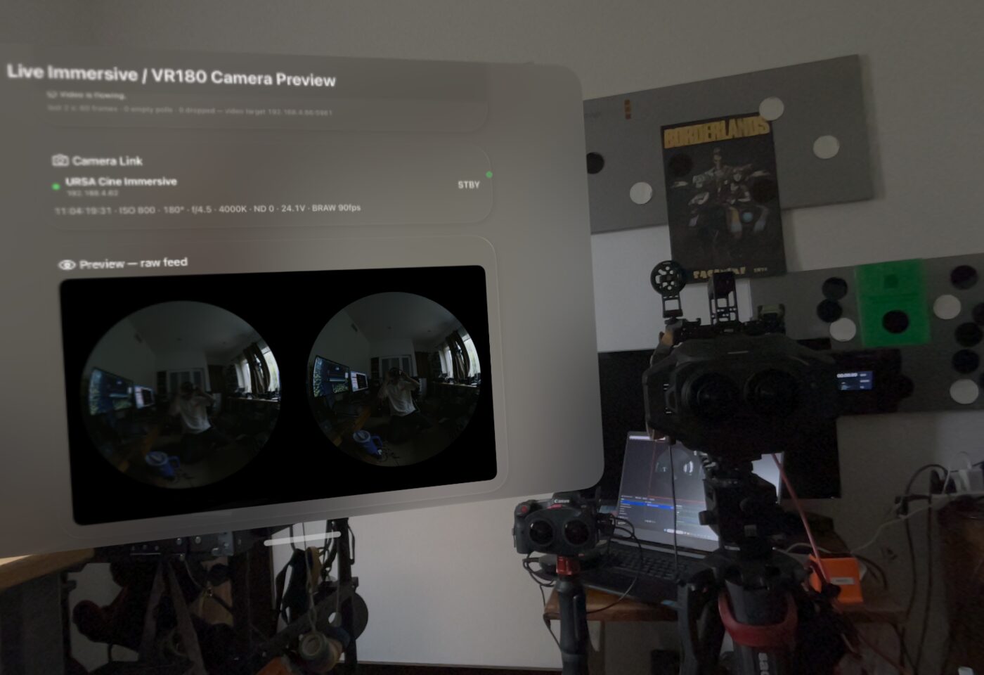 The Live Camera window in Spatial Film floating in Apple Vision Pro passthrough over a real URSA Cine Immersive rig, showing Camera Link telemetry and the raw dual fisheye preview