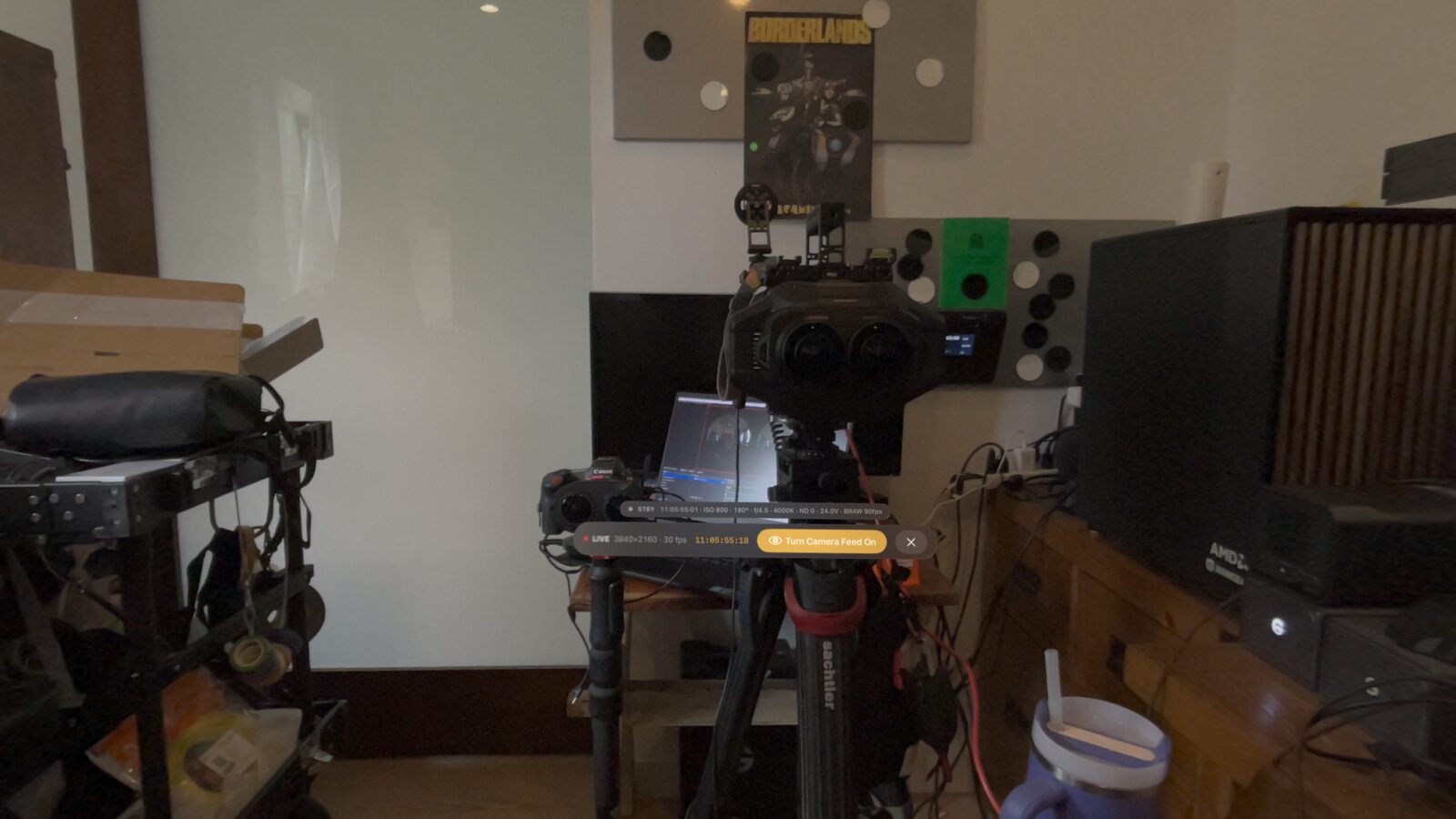 Vision Pro passthrough showing the real URSA Cine Immersive rig with the floating LIVE 4K status, timecode, and the one-tap Turn Camera Feed On button