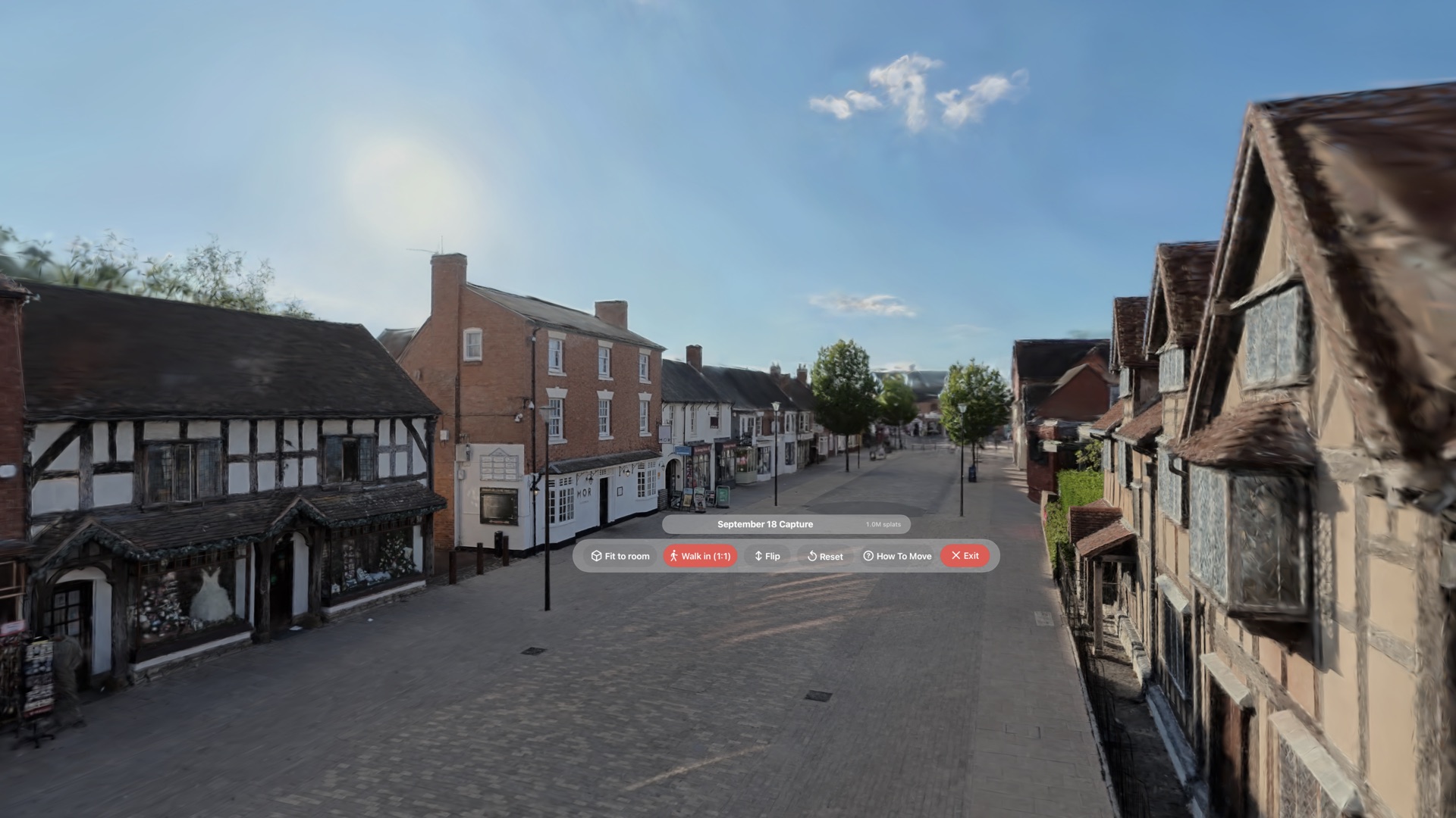 The Splat Player control pill floating in the Henley Street scene, reading Fit to room, Walk in 1:1, Flip, Reset, How To Move and Exit, with the scene name and a 1.0M splats count above it