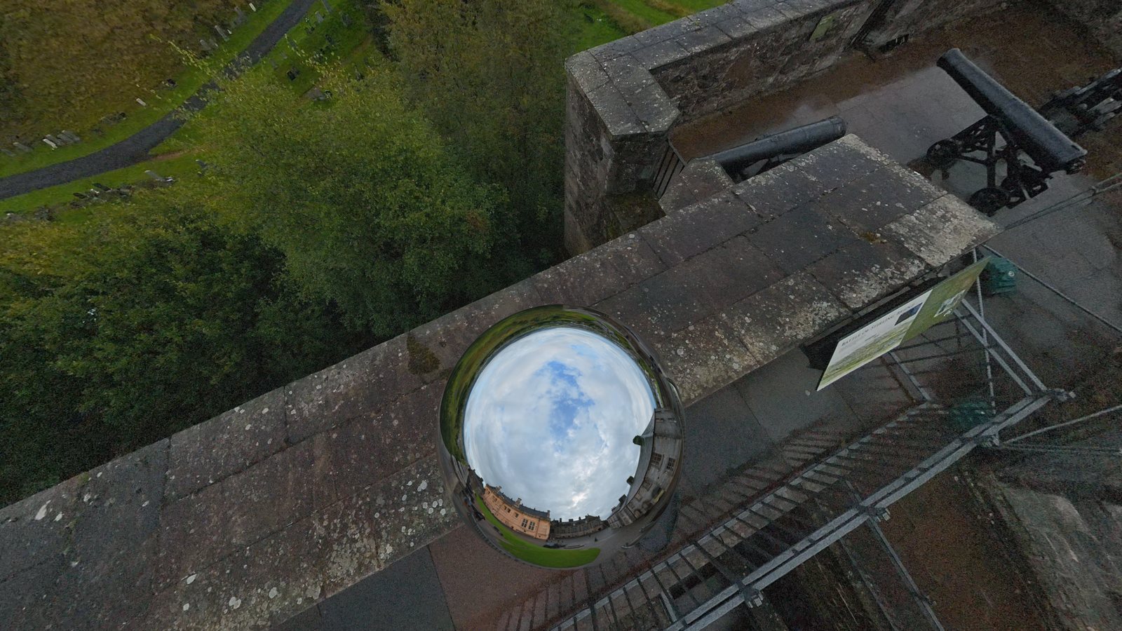 Chrome Ball, Shape 1: a chrome ball reflecting the sky and castle covers the operator below the camera on a castle rampart.